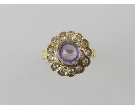 A yellow metal amethyst and diamond set flower ring, centred with an amethyst cabochon within diamond reserves, the shank sta