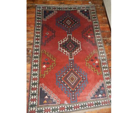 A Persian red ground Hamadan carpet, having geometric quartered field, fringed L.185cm W.130cm