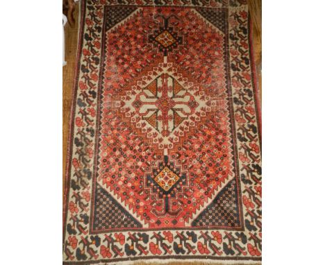 A Caucasian red and cream ground carpet, having a quartered foliate field, multi-bordered and fringed L.200cm W.135cm