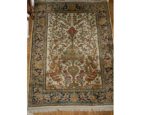 A Persian style floral carpet, the field decorated with a floral urn, multi-bordered and fringed L.175cm W.133cm