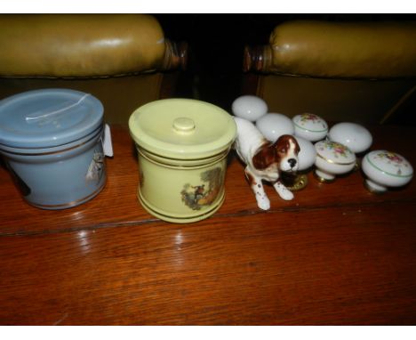 A collection of various ceramic door knobs, a Beswick pottery spaniel, and two Denby jars and covers. 