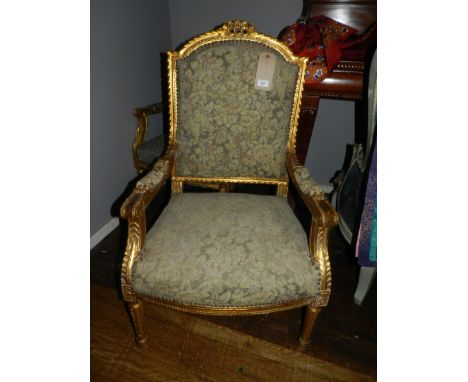 A pair of French Louis XV style gilt framed fauteuil, the floral stud upholstered tapestry backrest and seat raised on turned