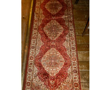 A Persian style part-silk Kum running carpet, with a foliate geometric field, multi-bordered and fringed L.210cm W.70cm