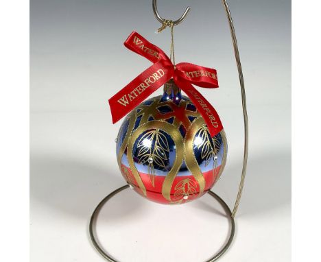 Handcrafted glass bauble features a stunning peacock inspired design, with gold ribbons resembling a feather tail, elegantly 