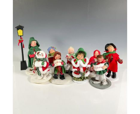 This is a merry group of carolers in various sizes and poses. along with a tall lamp post. Annalee hang tag. Largest piece me