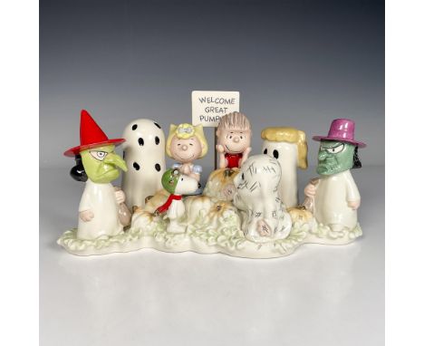 Glossy porcelain with hand painted details and dainty gold accents, featuring Snoopy as an aviator, Lucy with a mask, and a s