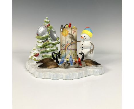 This acrylic Christmas figurine features a snowman conducting a meteorology lecture to the surrounds birds above a patch of s