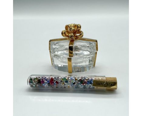 Clear crystal gilt wrapped hinged box. Included is a tube of colored crystal rhinestones. Swarovski backstamp. 210827. This i
