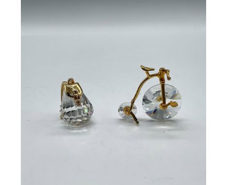 Faceted crystal miniatures adorned with gilded accents. Lot includes Knapsack 183281 and Penny Farthing Bicycle 180578. Swaro