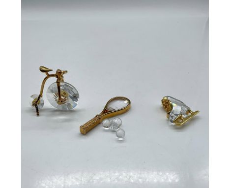 Crystal gilded miniature pieces. Lot includes Tennis Racket with balls 183280, Penny Farthing Bicycle 180578 and Ice Skate 18