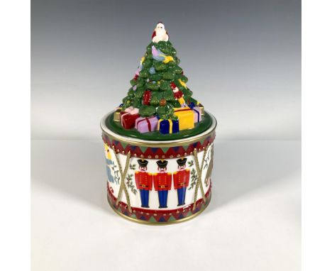 Glossy, hand painted porcelain with gold gilded details. Decorated with Santa on top of a Christmas tree lid. Jar features a 