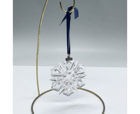 Beautiful crystal snowflake created for the year 1999. Has a blue ribbon that can be used to hang as an ornament. Swarovski e
