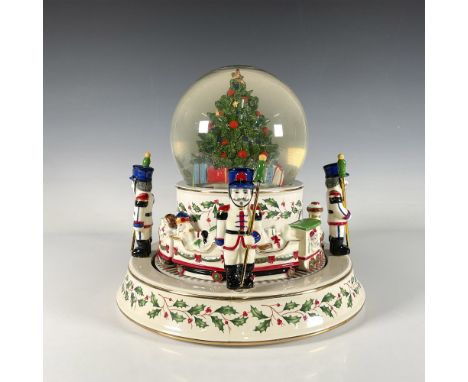 This Lenox Christmas table centerpiece features a snow globe with a light function and an automatic snow system. When turned 
