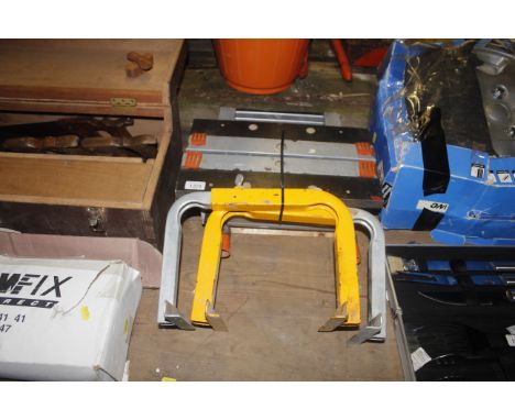 A work bench clamp and two metal adjustable clamps