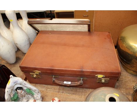 A Joseph Bramah leather suitcase initialled J.M. with contents of three glass and silver topped jars and three smaller leathe
