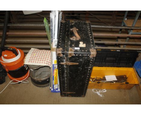 A metal bound traveling trunk with twin handles 