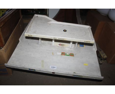 A wooden child's toy car garage and one other