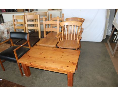 Two pine effect slat back elbow chairs and two ladder backed dining chairs and a pine coffee table 