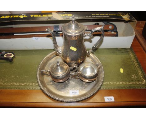 A silver plated tray and three piece tea set