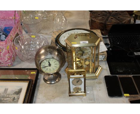 An Acctim anniversary clock, a battery operated mantel clock in the form of a globe, a carriage clock AF and a Seiko quartz w