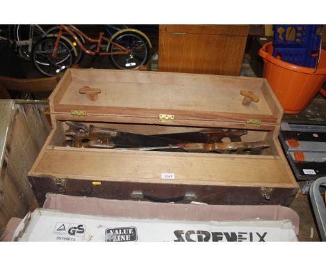 A wooden carpenters tool chest with internal fitted draw and contents of hand saws, screw drivers etc 