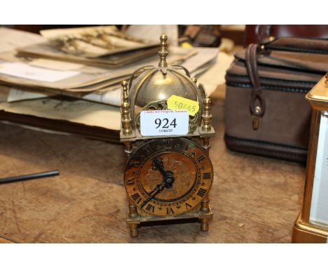 A brass lantern clock having reproduction movement