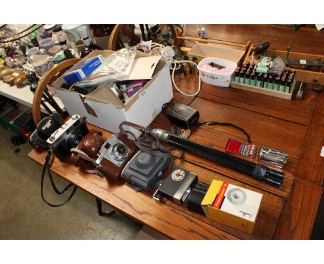 A Canon QL19 camera, a Kodak camera, tripod and various accessories