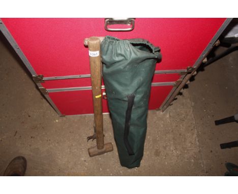 A wooden handled digging fork, sledge hammer, folding camping chair