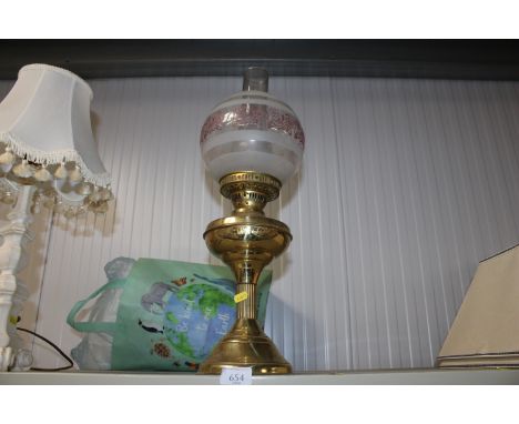 A brass oil lamp and shade