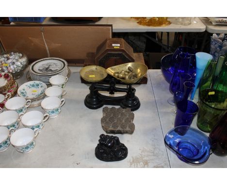 An oak cased two hole mantel clock, a set of scales and weights, a resin figure of a Buddha and a printers block 