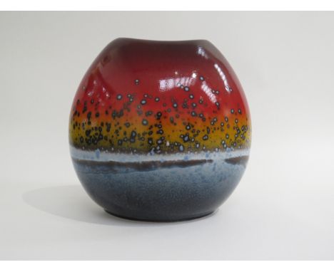 A Poole Pottery 'Sunset' vase of purse form in reds, ochre and blues. Marks to base. 18cm high 