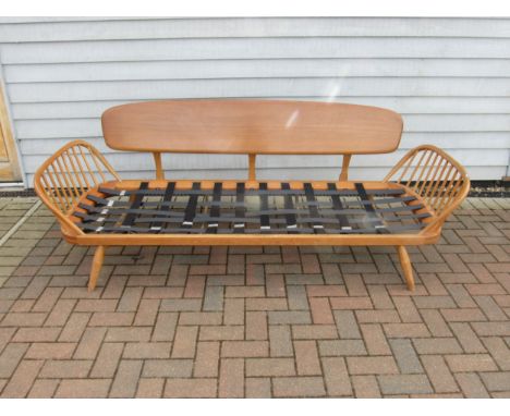 An Ercol light elm sofa "Day Bed" with plank back. No seat pads, 206cm x 77cm x 76cm high 