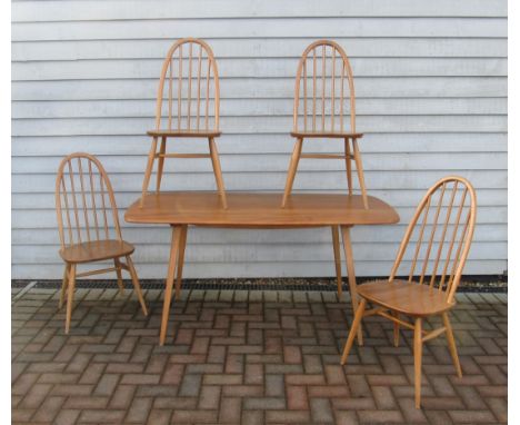 An Ercol light elm dining table and four high hoop back chairs. Table 152cm x 77cm x 71cm high 