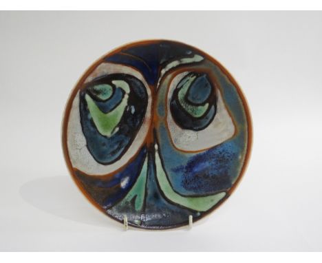 A Poole Pottery Delphis plate in blues and greens. Blue studio backstamp. 20.5cm diameter 