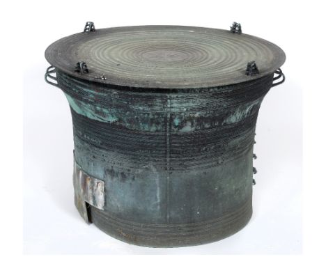 A Burmese bronze rain drum, of wasted circular form, the central stellar motif enclosed by concentric rings, section missing/