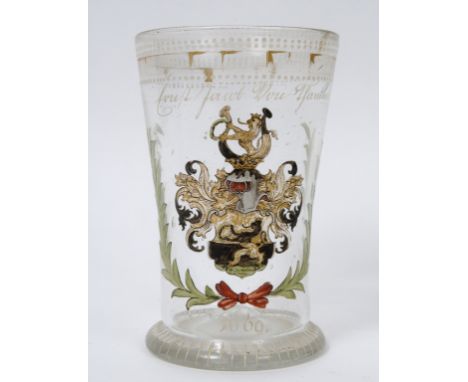 A German drinking glass, painted an enamel crest and dated 1669, chipped, 15.5 cm high See inside front cover colour illustra