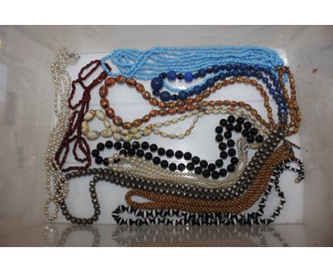 A box of simulated pearl and bead necklaces