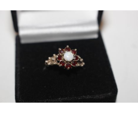 A silver opal and garnet set ring