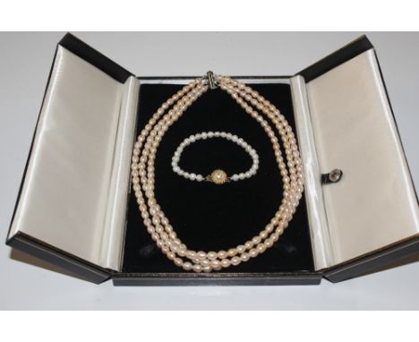 A three strand cultured pearl necklace with sterling silver clasp
