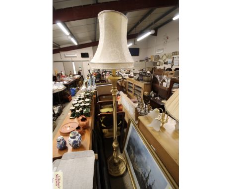 A cream painted standard lamp with cream silk shade