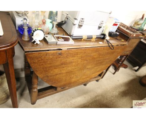 An antique oak gate leg dining table