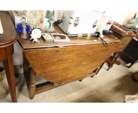 An antique oak gate leg dining table