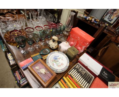 An oil lamp, a cast iron money box, decorative plates, a magnifying glass etc