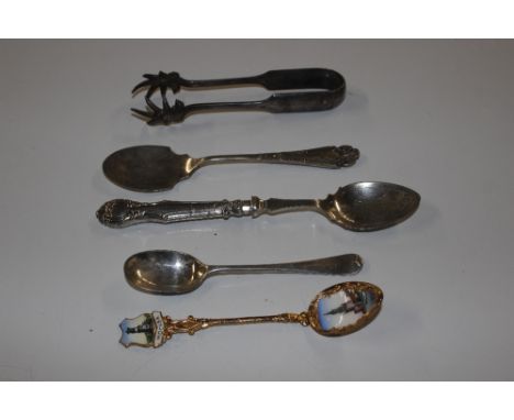 A silver handled preserve spade, another preserve spade and an enamel decorated souvenir spoon, other spoons and a pair of su