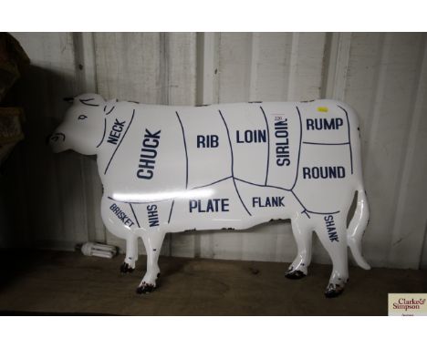 An enamel cow sign