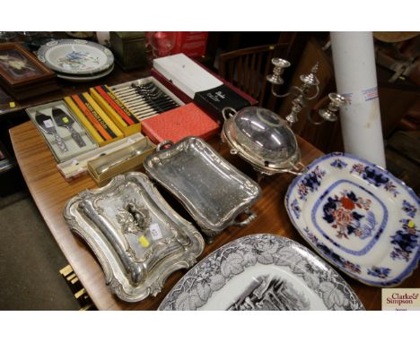 A plated three light candelabra, a plated revolving breakfast dish and two entree dishes