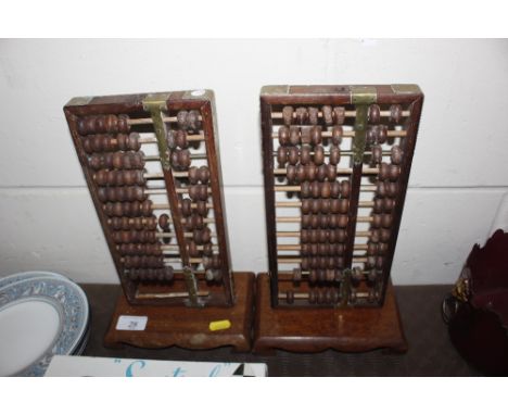 A pair of Chinese wooden abacus on stands 