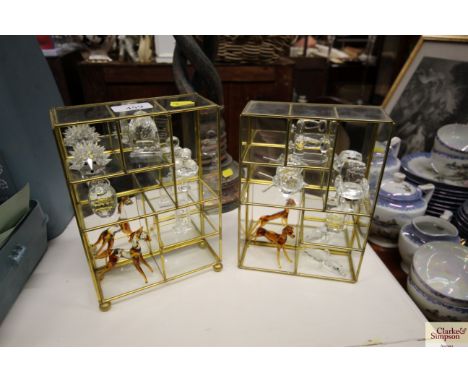 A pair of small mirrored shelf units complete with decorative glass figures