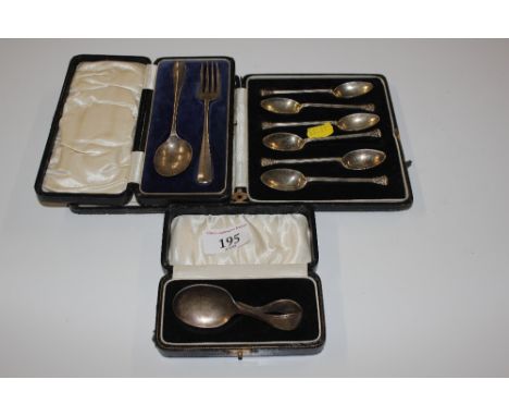 A cased set of six silver spoons, a silver feeding spoon and a cased silver fork and spoon
