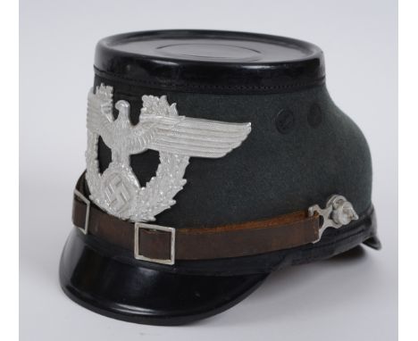 A German Shako helmet, with a Hans Romer label  See illustration